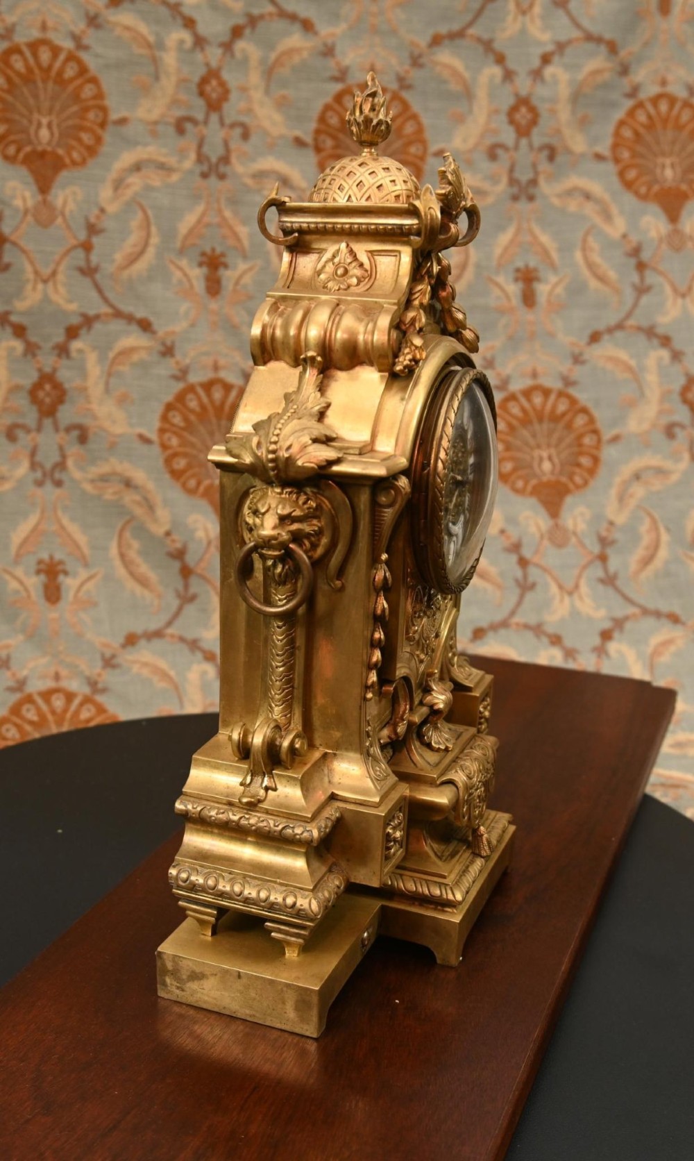 A 19th-century Louis XVI style gilt bronze clock garniture set comprising a central ornate mantel clock flanked by two matching five-light candelabras. View XII
