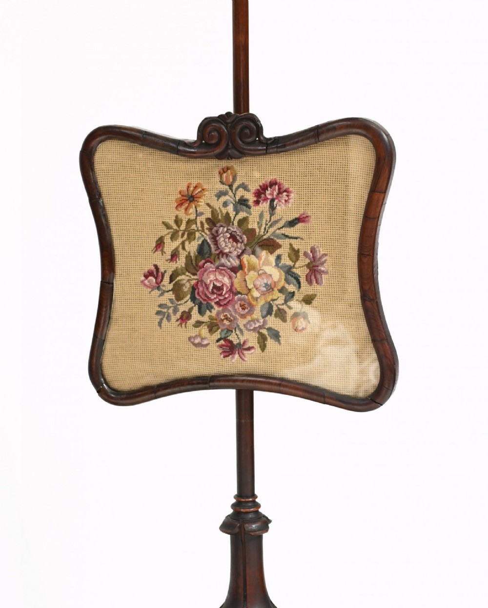 A pair of 19th-century Regency pole screens crafted from dark rosewood with carved tripod bases and adjustable rectangular needlepoint tapestry panels. View IX