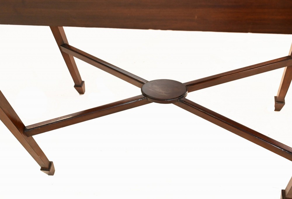 An antique mahogany ladies writing desk featuring a superstructure with drawers and cupboards, oval flame mahogany inlay, and an X-frame stretcher base. View IV