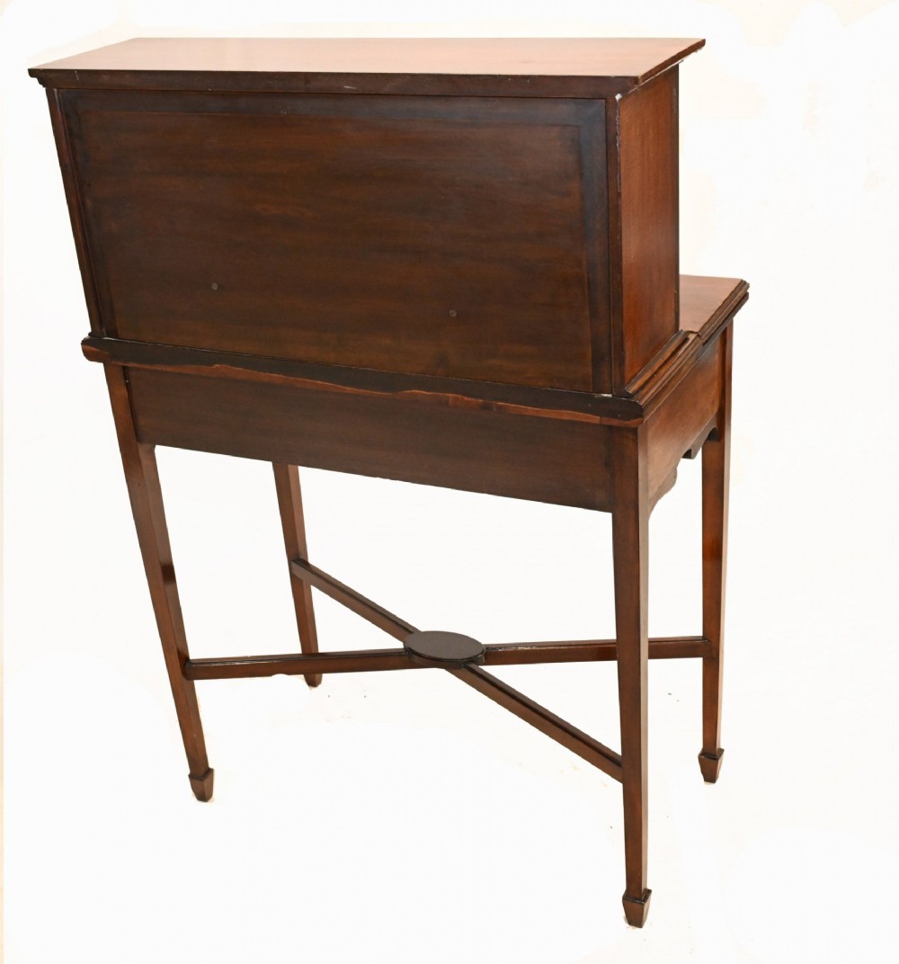 An antique mahogany ladies writing desk featuring a superstructure with drawers and cupboards, oval flame mahogany inlay, and an X-frame stretcher base. View IX