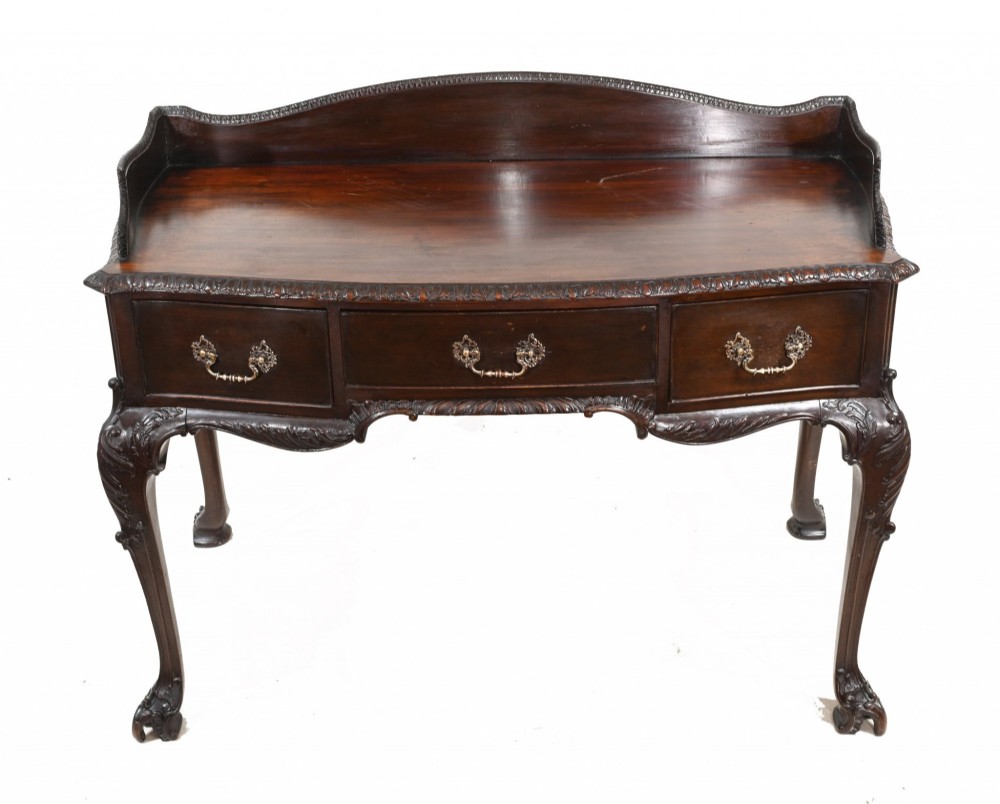 A dark mahogany Victorian console table featuring three drawers with decorative brass handles, carved cabriole legs, and a low gallery back. View II