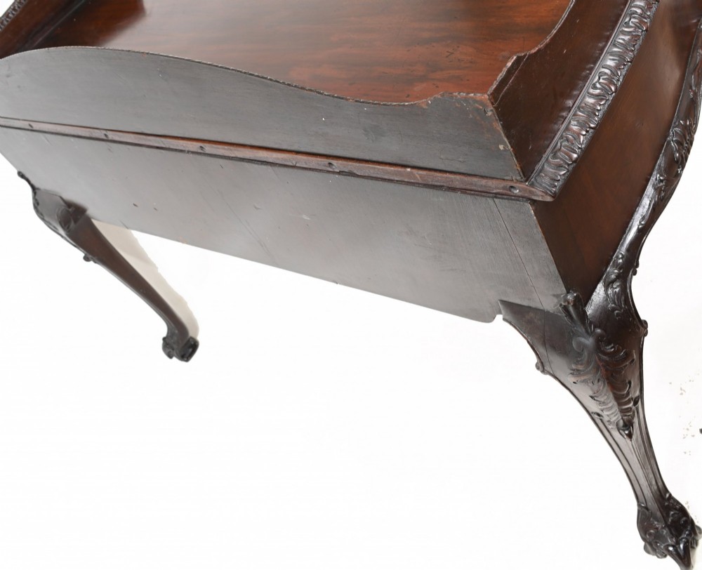 A dark mahogany Victorian console table featuring three drawers with decorative brass handles, carved cabriole legs, and a low gallery back. View VIII