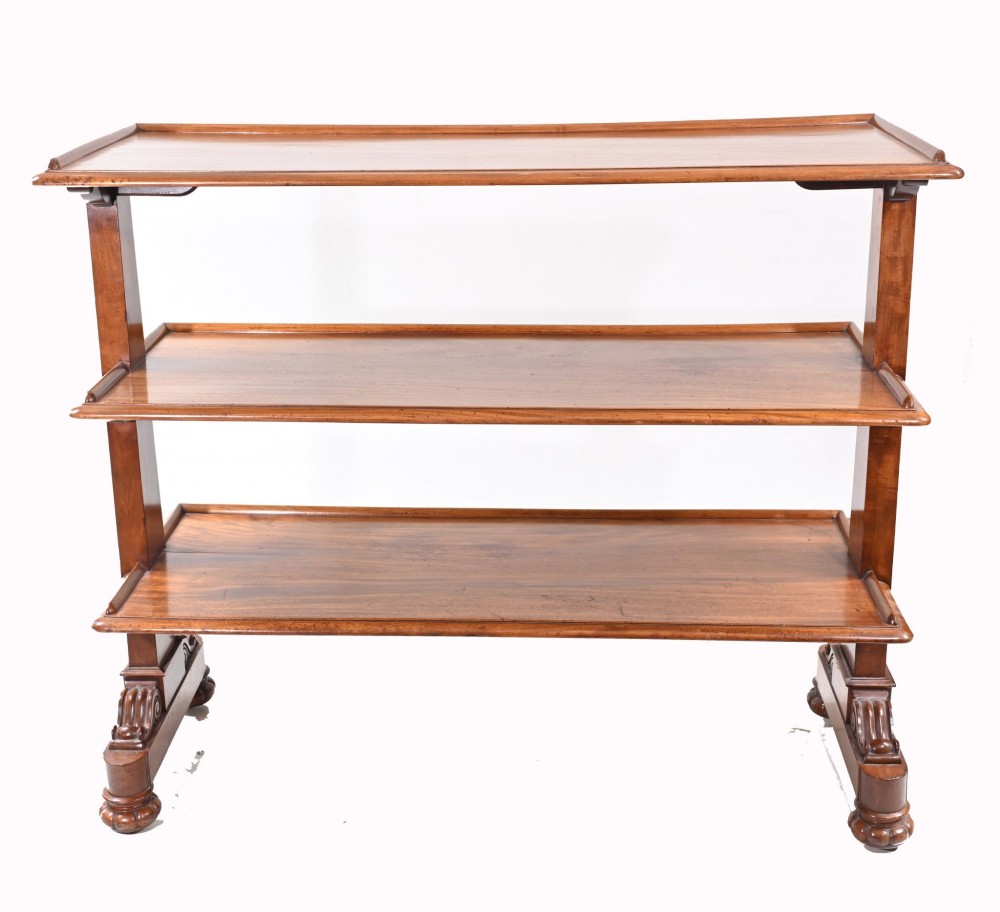A Victorian mahogany three-tiered dumb waiter buffet with moulded shelf edges and carved scroll feet. View III