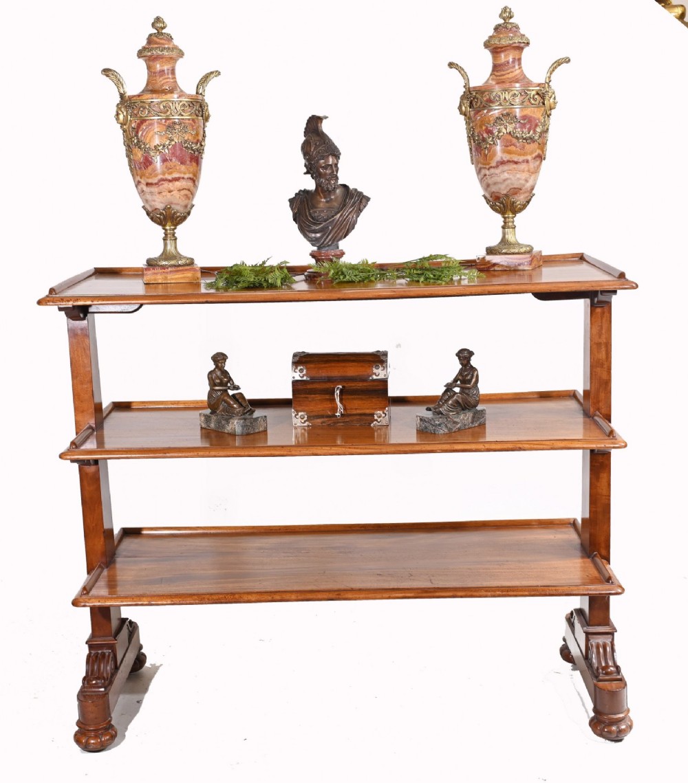 A Victorian mahogany three-tiered dumb waiter buffet with moulded shelf edges and carved scroll feet. View VII