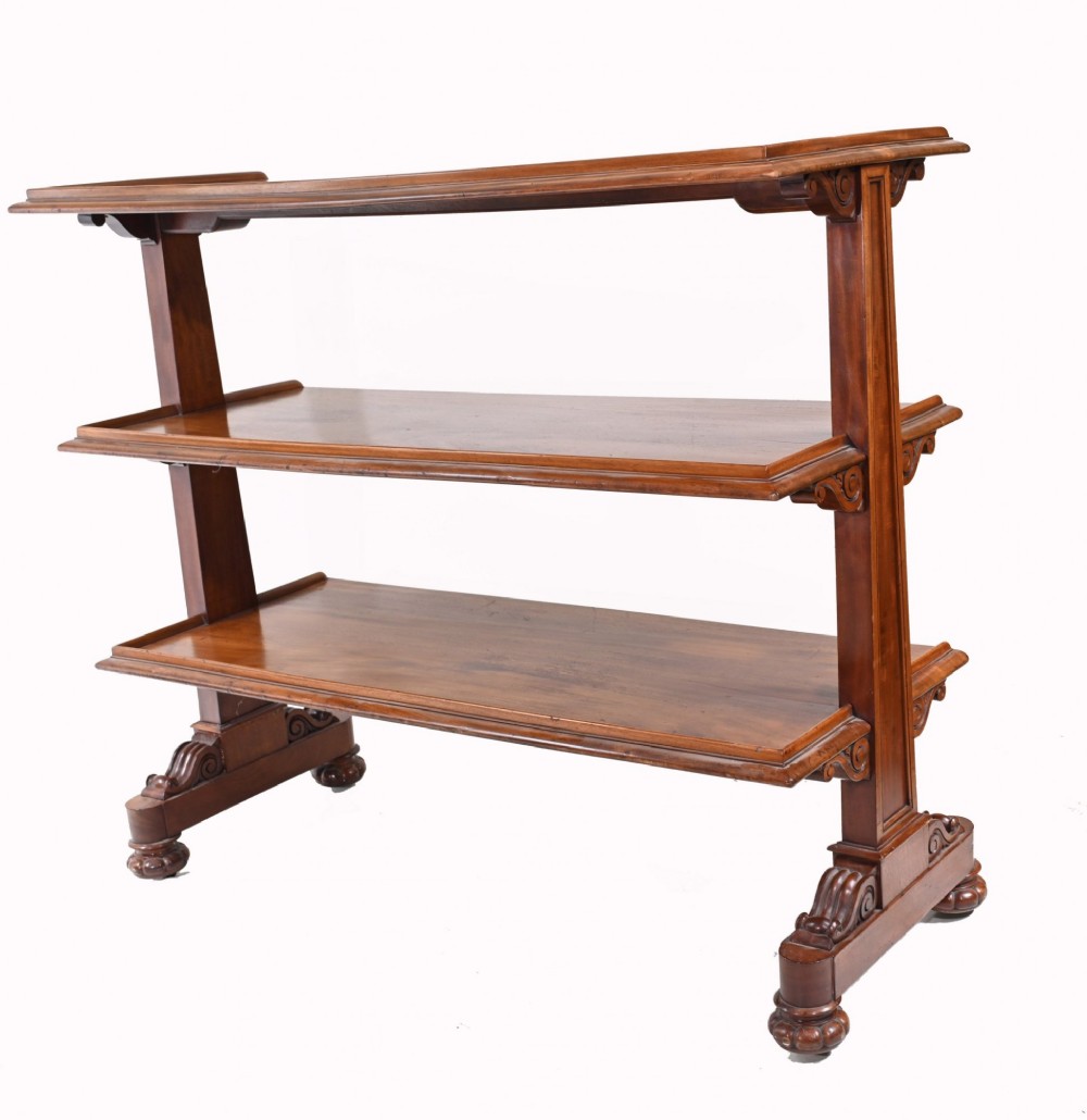 A Victorian mahogany three-tiered dumb waiter buffet with moulded shelf edges and carved scroll feet. View X