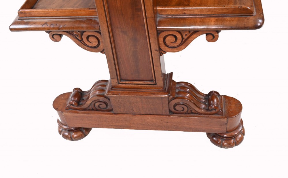 A Victorian mahogany three-tiered dumb waiter buffet with moulded shelf edges and carved scroll feet. View XI