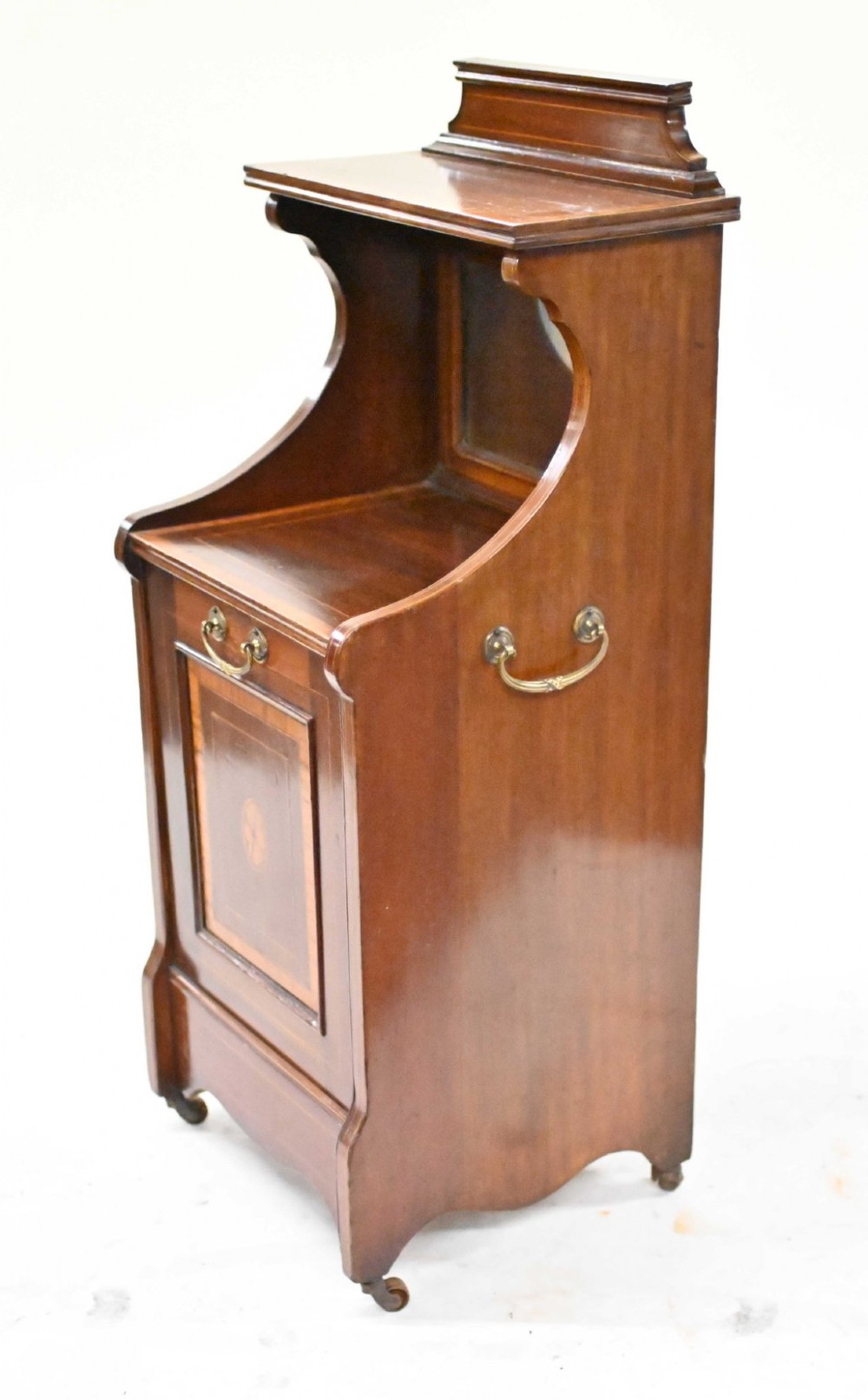 A late Victorian mahogany coal purdonium cabinet featuring satinwood marquetry inlay, a brass handle on the drop-front door, an upper shelf, and a small mirrored back panel. View II