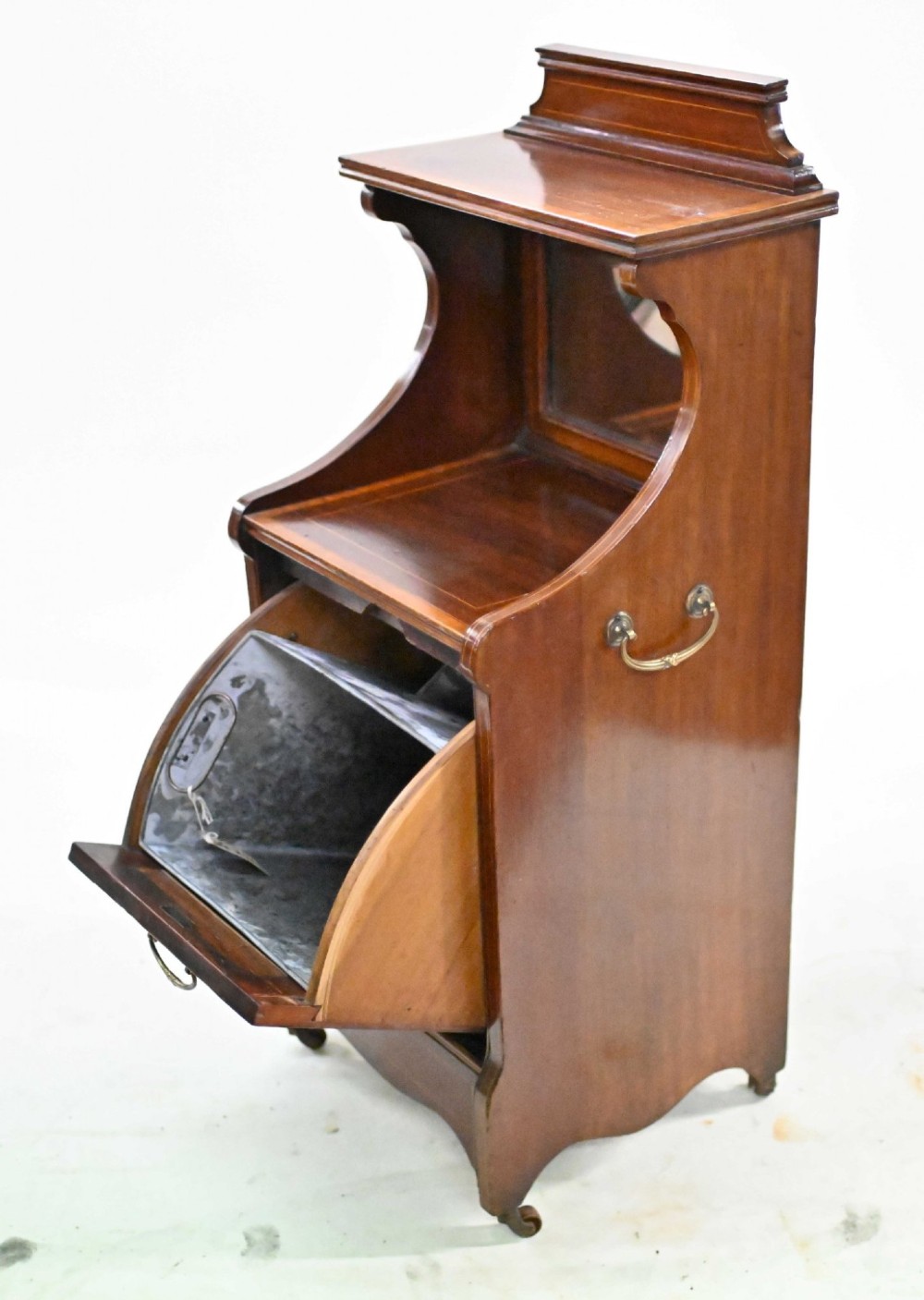 A late Victorian mahogany coal purdonium cabinet featuring satinwood marquetry inlay, a brass handle on the drop-front door, an upper shelf, and a small mirrored back panel. View VII