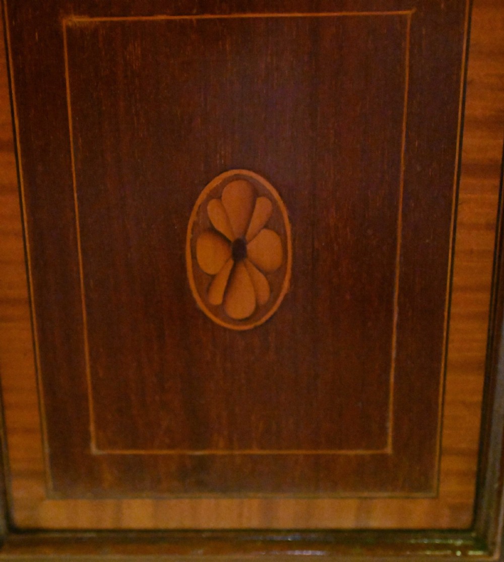 A late Victorian mahogany coal purdonium cabinet featuring satinwood marquetry inlay, a brass handle on the drop-front door, an upper shelf, and a small mirrored back panel. View VIII