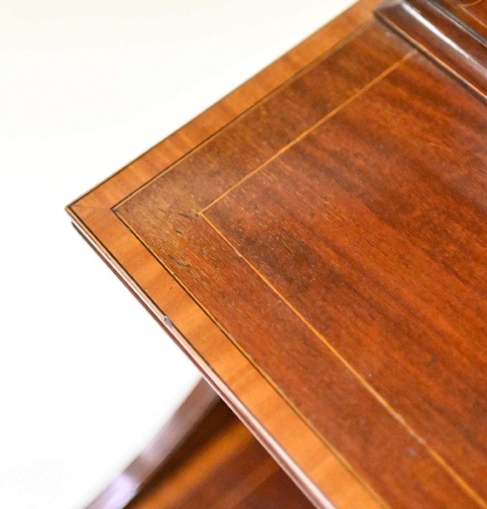 A late Victorian mahogany coal purdonium cabinet featuring satinwood marquetry inlay, a brass handle on the drop-front door, an upper shelf, and a small mirrored back panel. View IX