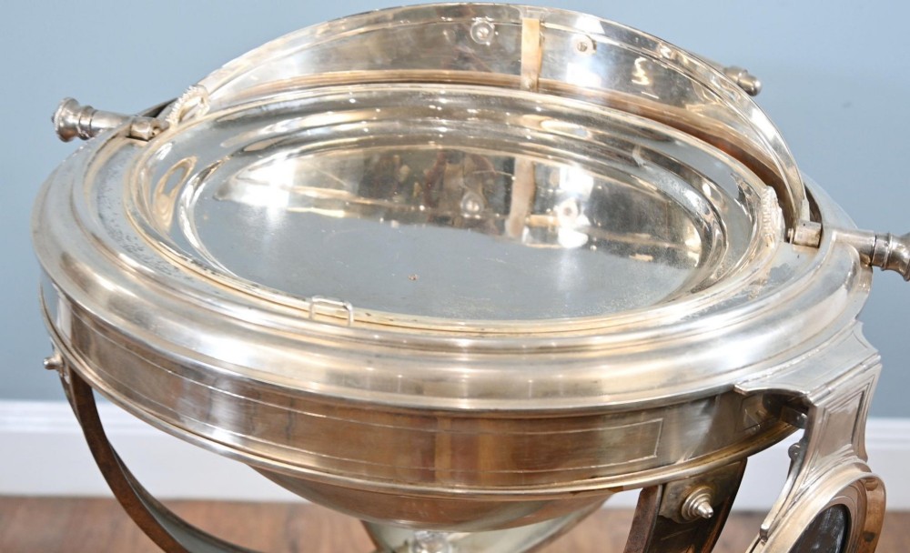 A Victorian silver-plated carvery trolley with a domed retractable cover set atop a carved mahogany pedestal base with swivel castors. View III