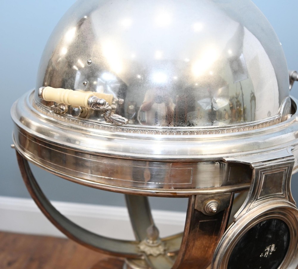 A Victorian silver-plated carvery trolley with a domed retractable cover set atop a carved mahogany pedestal base with swivel castors. View IV