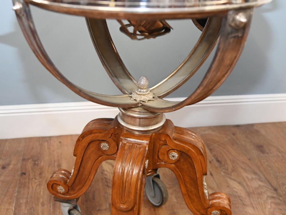A Victorian silver-plated carvery trolley with a domed retractable cover set atop a carved mahogany pedestal base with swivel castors. View V