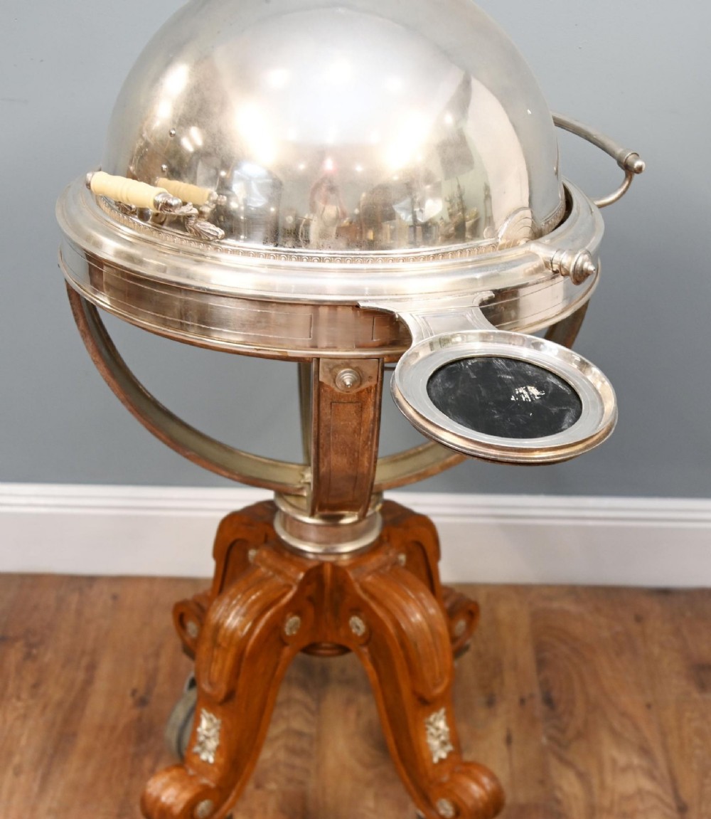 A Victorian silver-plated carvery trolley with a domed retractable cover set atop a carved mahogany pedestal base with swivel castors. View VII