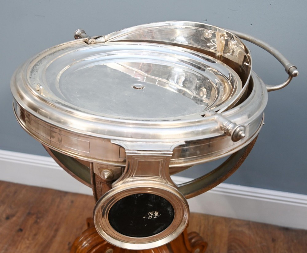 A Victorian silver-plated carvery trolley with a domed retractable cover set atop a carved mahogany pedestal base with swivel castors. View IX