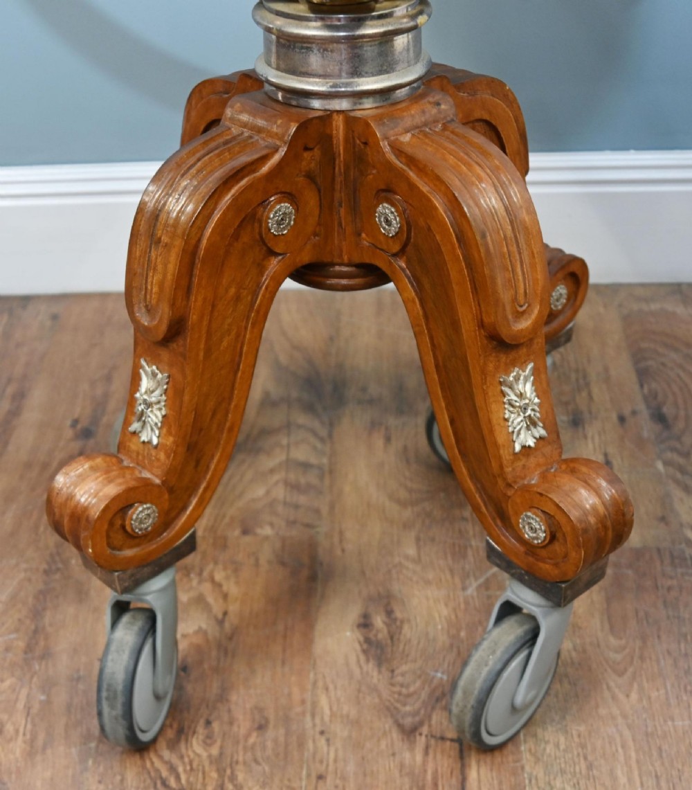 A Victorian silver-plated carvery trolley with a domed retractable cover set atop a carved mahogany pedestal base with swivel castors. View X