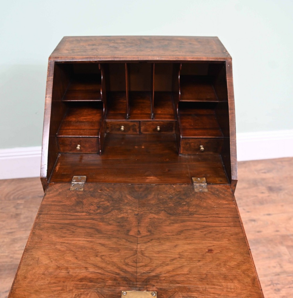 A late Victorian walnut slant-front bureau desk with four drawers and brass teardrop handles. View X