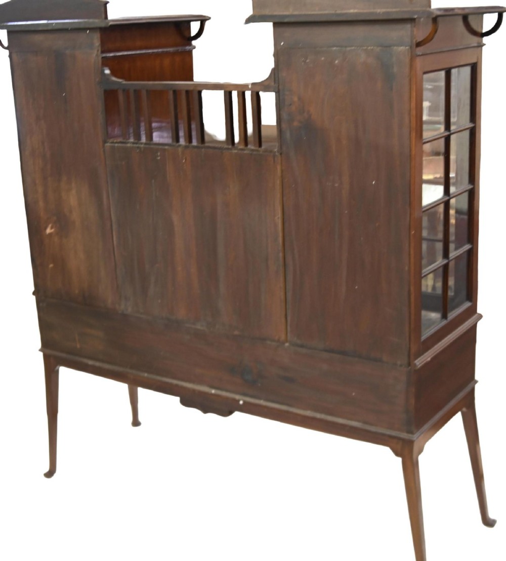 An Edwardian Art Nouveau dark mahogany drinks cabinet featuring stylised botanical marquetry inlays, twin glazed side doors, two lower drawers, and slender splayed legs. View VII