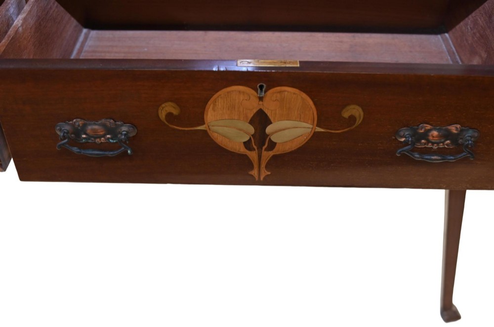 An Edwardian Art Nouveau dark mahogany drinks cabinet featuring stylised botanical marquetry inlays, twin glazed side doors, two lower drawers, and slender splayed legs. View XI