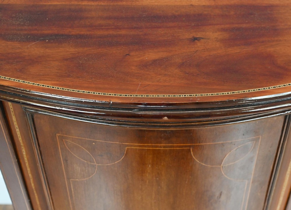 A late Victorian bow-fronted mahogany side cabinet with delicate boxwood line inlay, a single door with key, and slender square tapered legs. View III