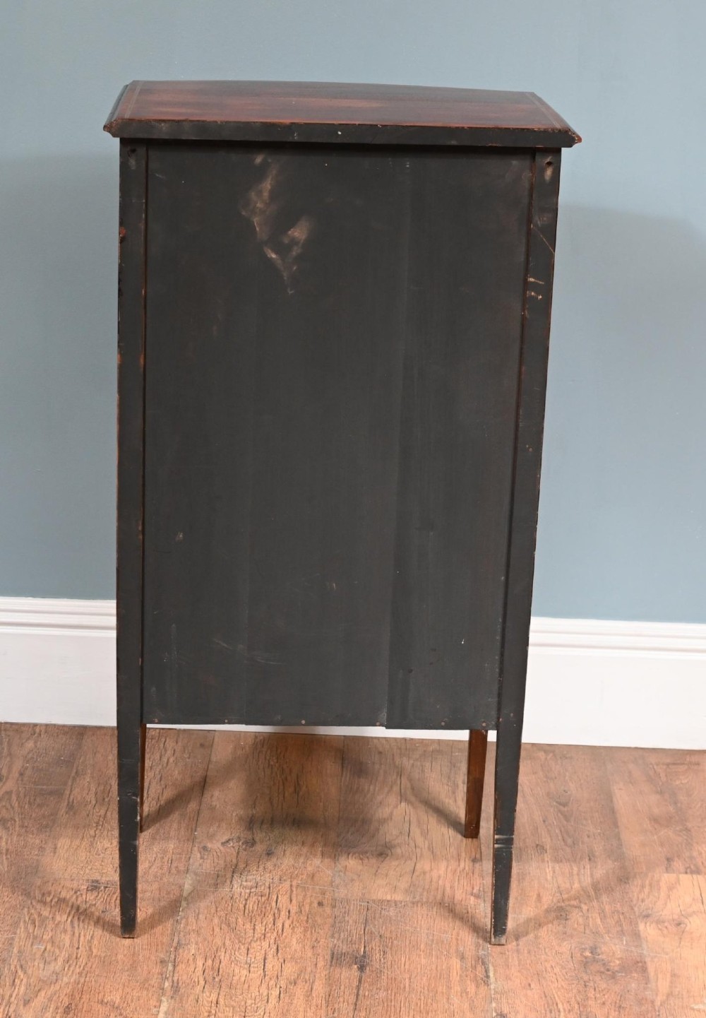 A late Victorian bow-fronted mahogany side cabinet with delicate boxwood line inlay, a single door with key, and slender square tapered legs. View VII