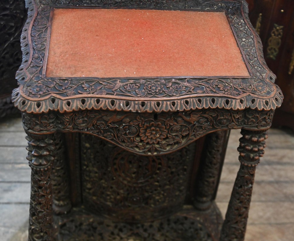 A dark hardwood Burmese Davenport desk with pierced carved floral decoration, an openwork gallery, and a terracotta leather writing surface. View VI