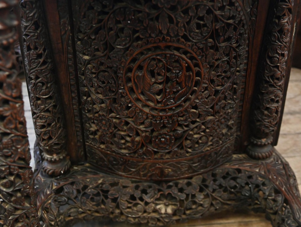 A dark hardwood Burmese Davenport desk with pierced carved floral decoration, an openwork gallery, and a terracotta leather writing surface. View VIII