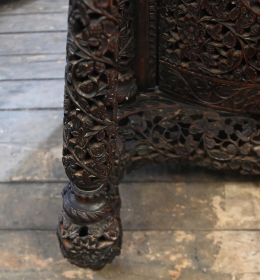 A dark hardwood Burmese Davenport desk with pierced carved floral decoration, an openwork gallery, and a terracotta leather writing surface. View IX