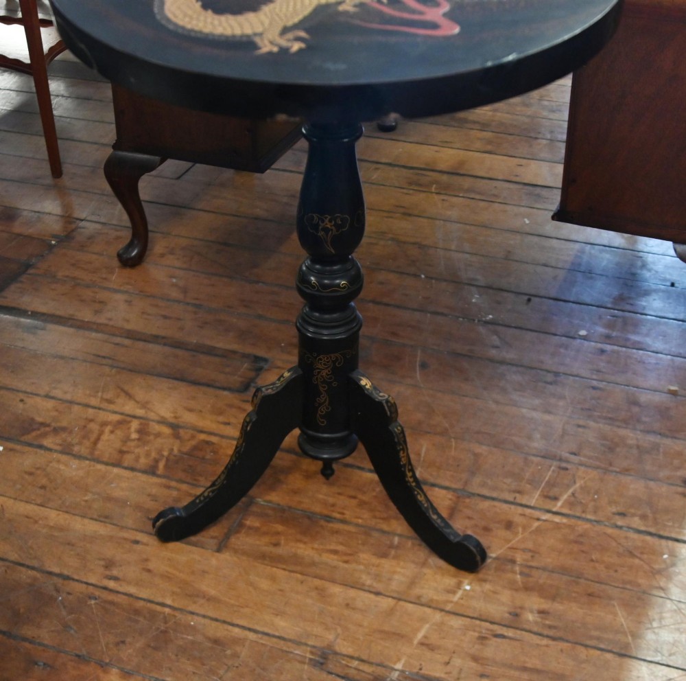 A black lacquered circular tilt-top side table featuring a gilt dragon motif, supported on a turned central column and tripod pedestal legs. View VI