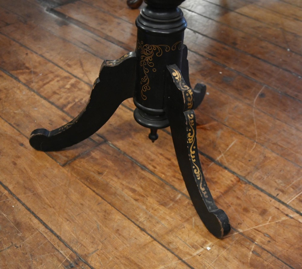 A black lacquered circular tilt-top side table featuring a gilt dragon motif, supported on a turned central column and tripod pedestal legs. View VII