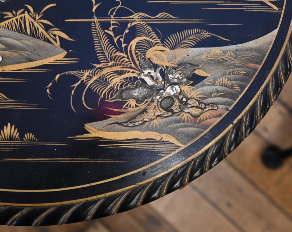 A circular black lacquered side table featuring gilded Chinoiserie landscape motifs, bone inlay details, carved cabriole legs, and ball and claw feet. View II
