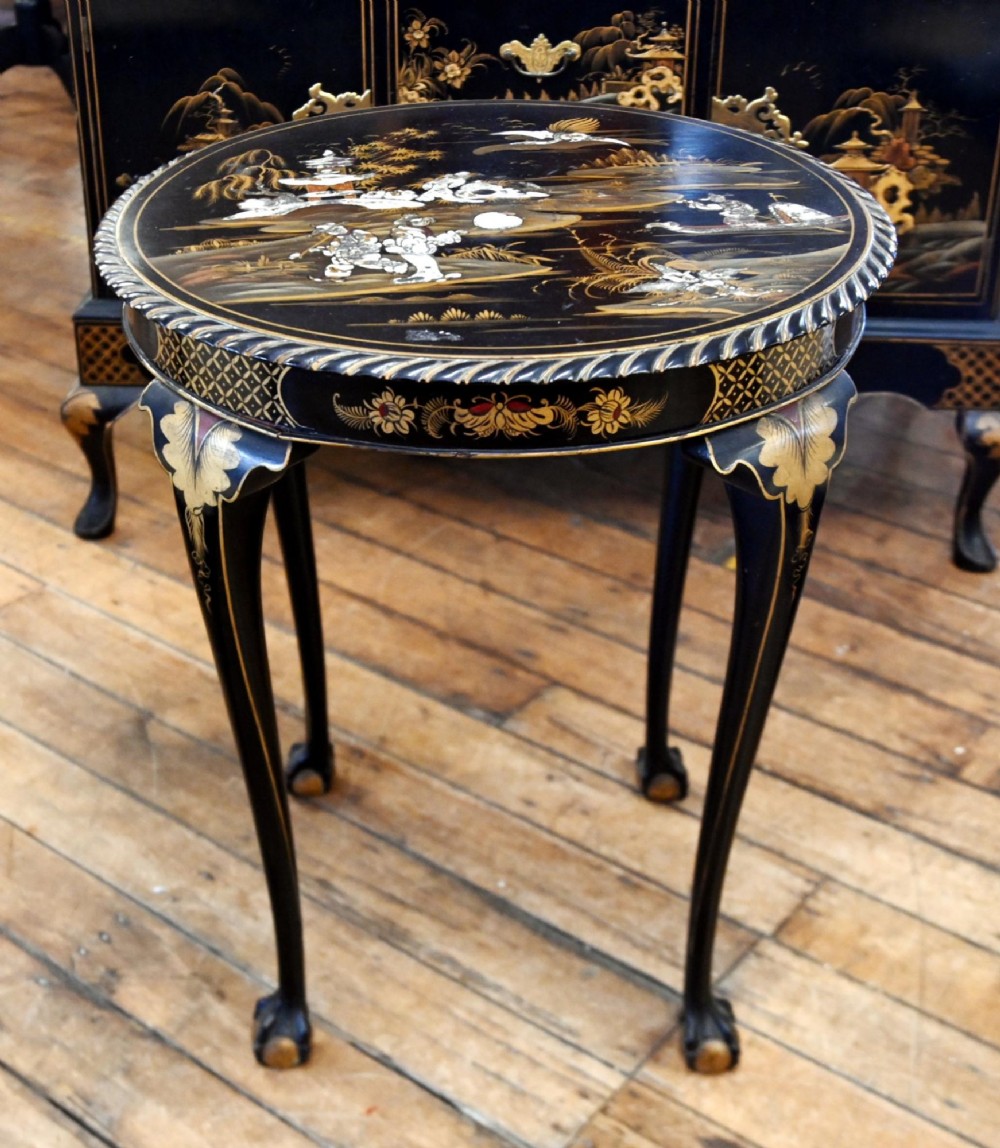A circular black lacquered side table featuring gilded Chinoiserie landscape motifs, bone inlay details, carved cabriole legs, and ball and claw feet. View V