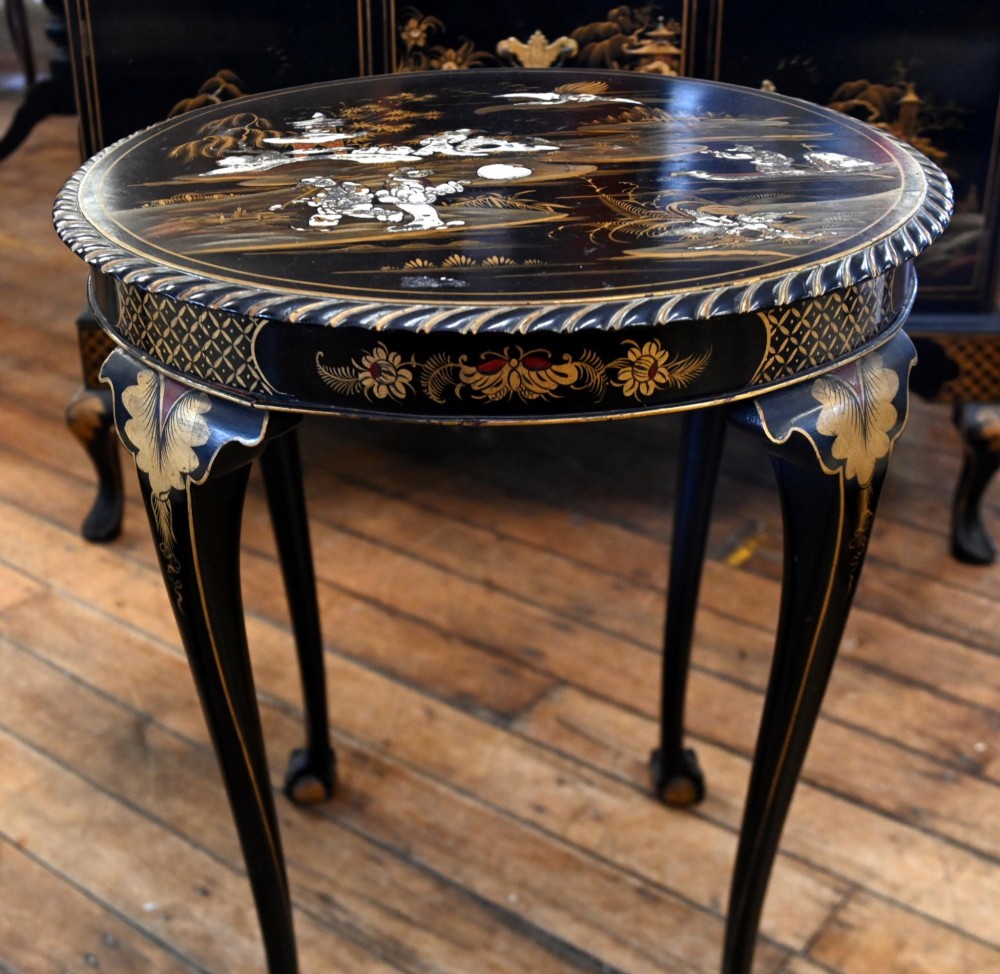 A circular black lacquered side table featuring gilded Chinoiserie landscape motifs, bone inlay details, carved cabriole legs, and ball and claw feet. View VI