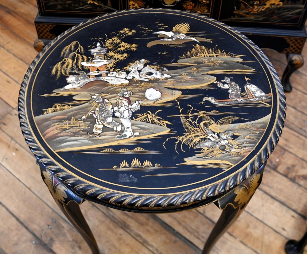 A circular black lacquered side table featuring gilded Chinoiserie landscape motifs, bone inlay details, carved cabriole legs, and ball and claw feet. View IX