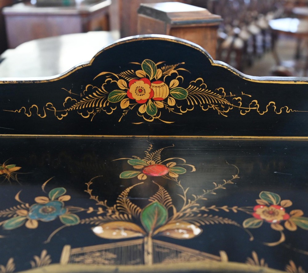 A black lacquered antique display cabinet featuring hand-painted gilded Chinoiserie scenes, two glazed side doors, and cabriole legs. View II