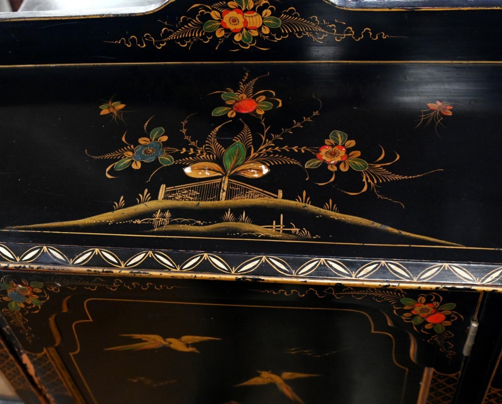 A black lacquered antique display cabinet featuring hand-painted gilded Chinoiserie scenes, two glazed side doors, and cabriole legs. View IV