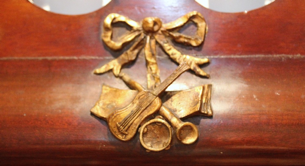 A tall rectangular Georgian mahogany wall mirror featuring a swan-neck pediment with a central urn finial, carved gilt accents, and a scrolled apron base. View III