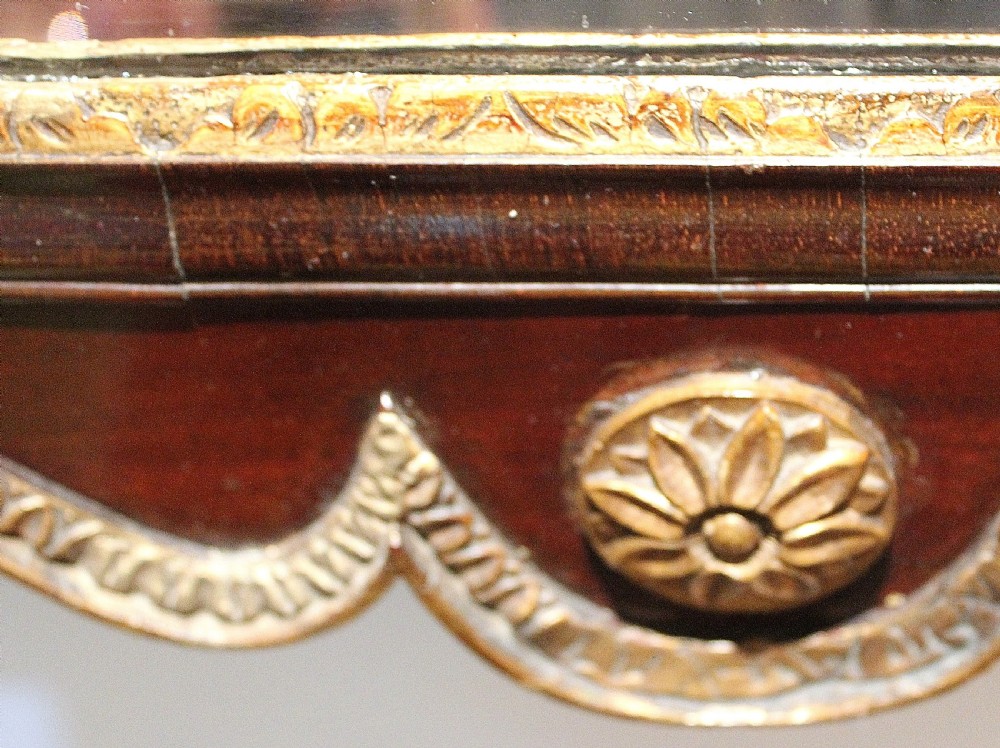 A tall rectangular Georgian mahogany wall mirror featuring a swan-neck pediment with a central urn finial, carved gilt accents, and a scrolled apron base. View V