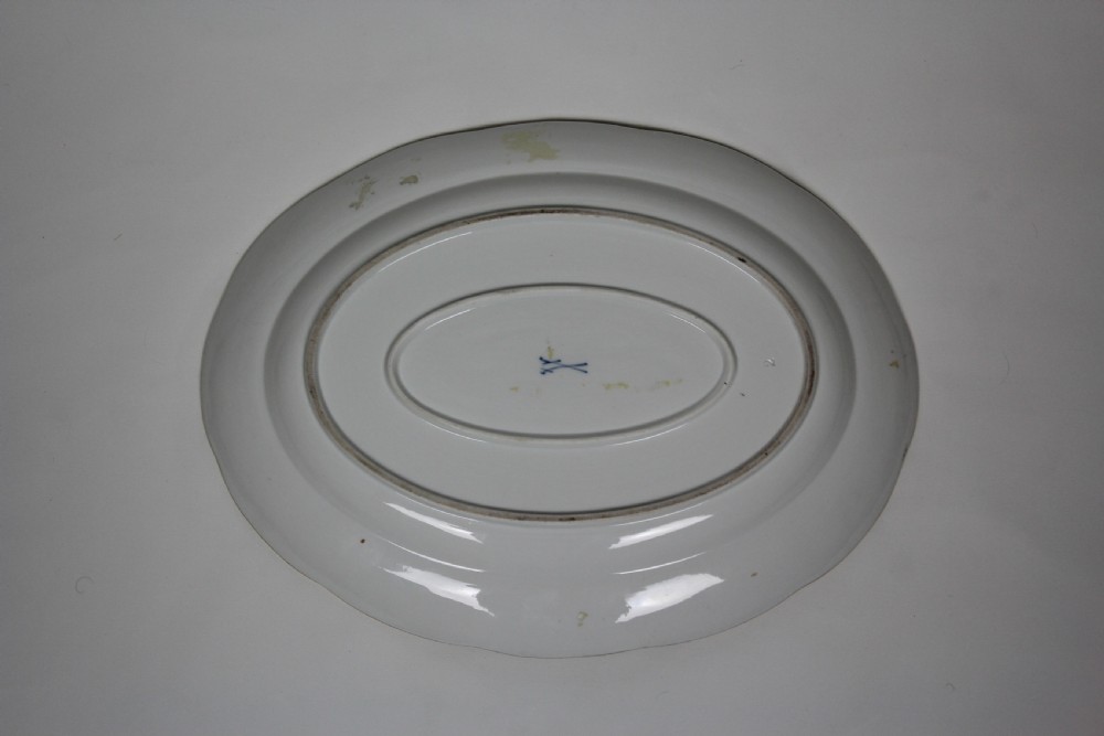 An oval white porcelain serving platter featuring a hand-painted yellow bird on a branch in the centre, surrounded by insect motifs on a basketweave rim with a gold edge. View II