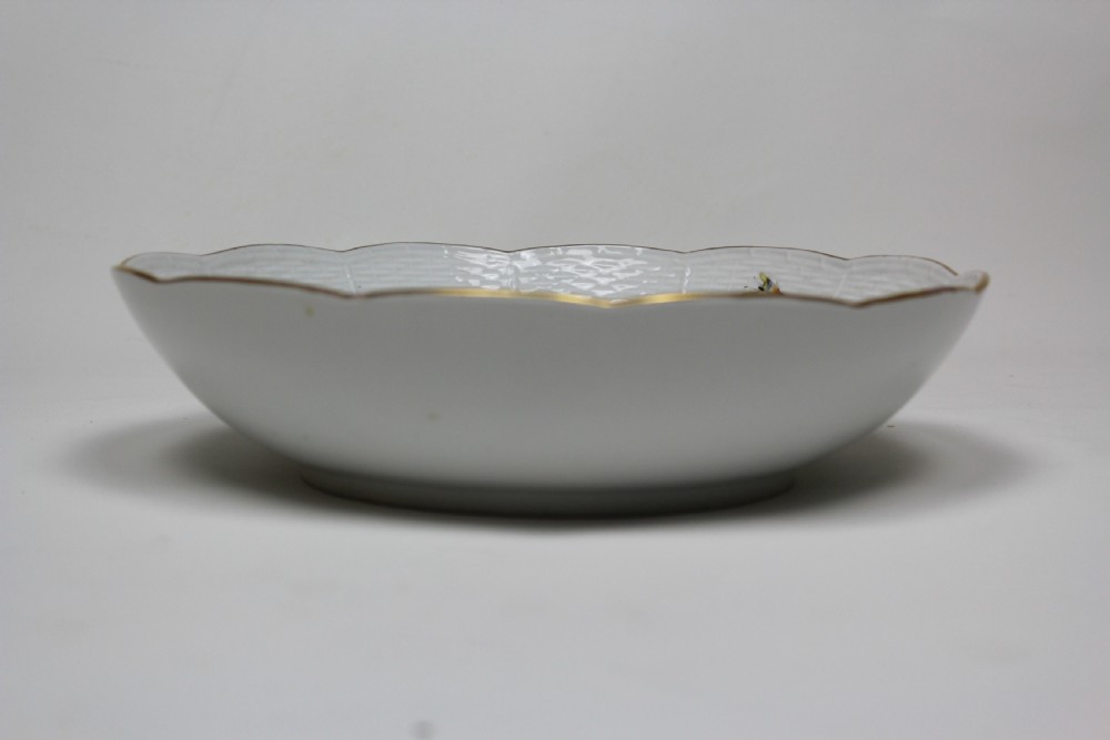 A circular white porcelain bowl featuring hand-painted bird and insect motifs with a basketweave embossed border and gilded rim. View III