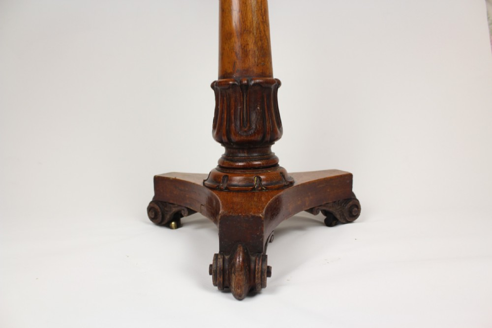 A golden oak jardiniere stand featuring a carved circular basin, a turned central column, and a triform base with scroll feet. View III