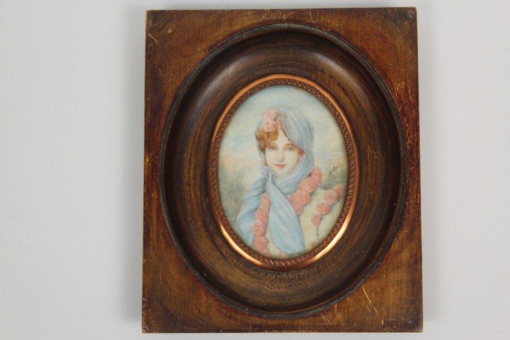 A pair of antique square dark wood framed portrait miniatures depicting two women dressed in historical attire. View IV