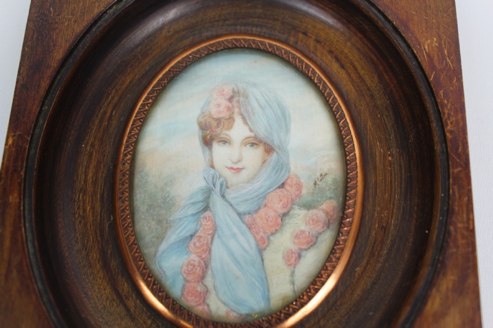 A pair of antique square dark wood framed portrait miniatures depicting two women dressed in historical attire. View V