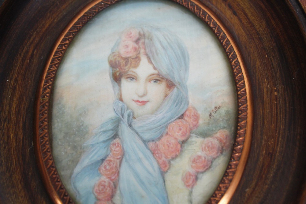 A pair of antique square dark wood framed portrait miniatures depicting two women dressed in historical attire. View VI
