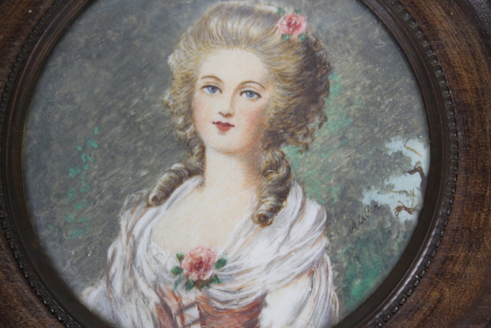 A pair of antique square dark wood framed portrait miniatures depicting two women dressed in historical attire. View VII