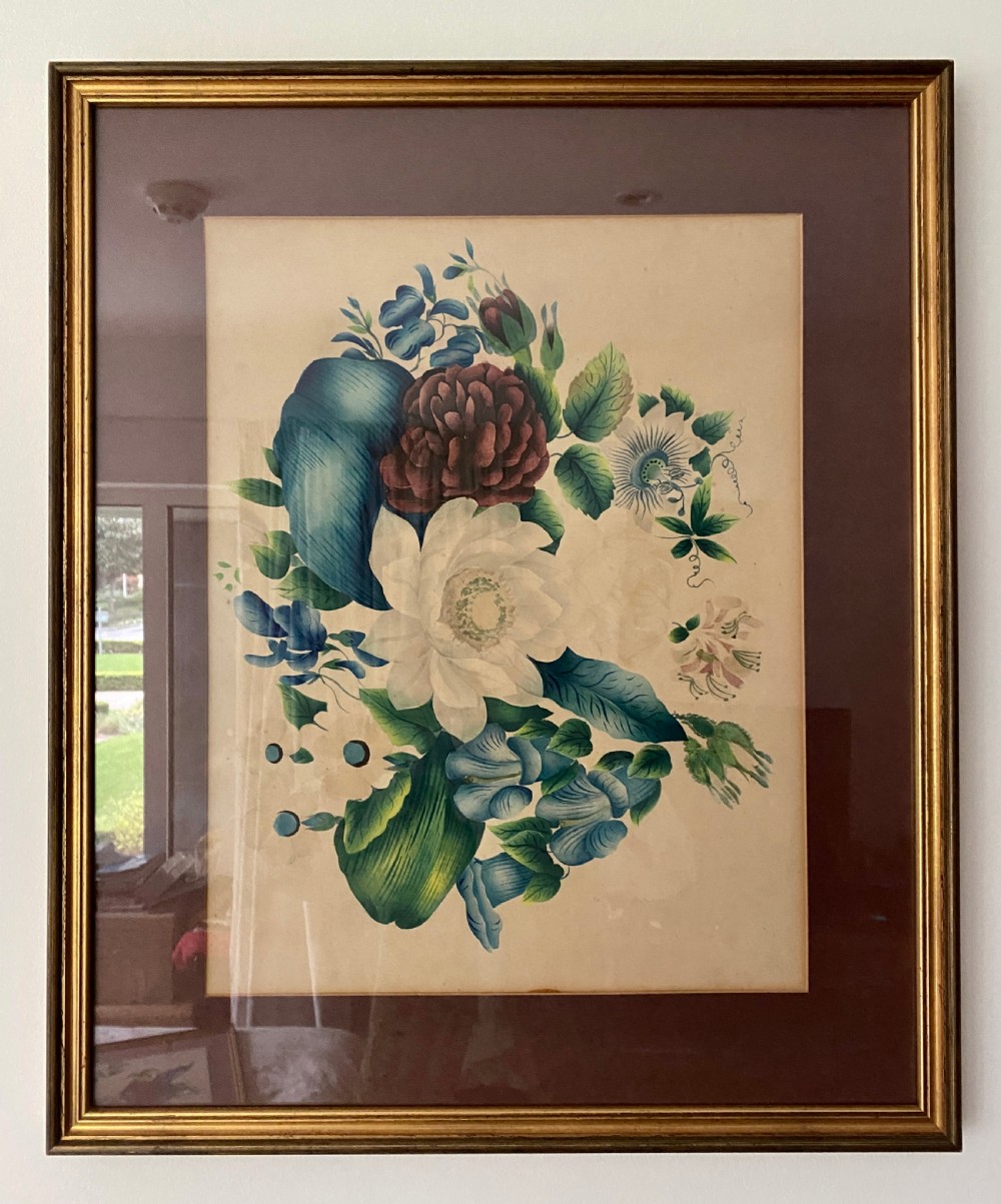 A framed 19th-century botanical print featuring a bouquet of blue, white, and purple flowers set within a dark mount and a gilded wooden frame.