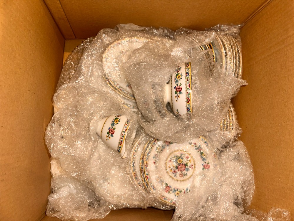 A collection of cream ceramic tableware featuring hand-painted floral motifs and gilded rims, including two teapots, a serving bowl, a gravy boat, and a square platter. View II