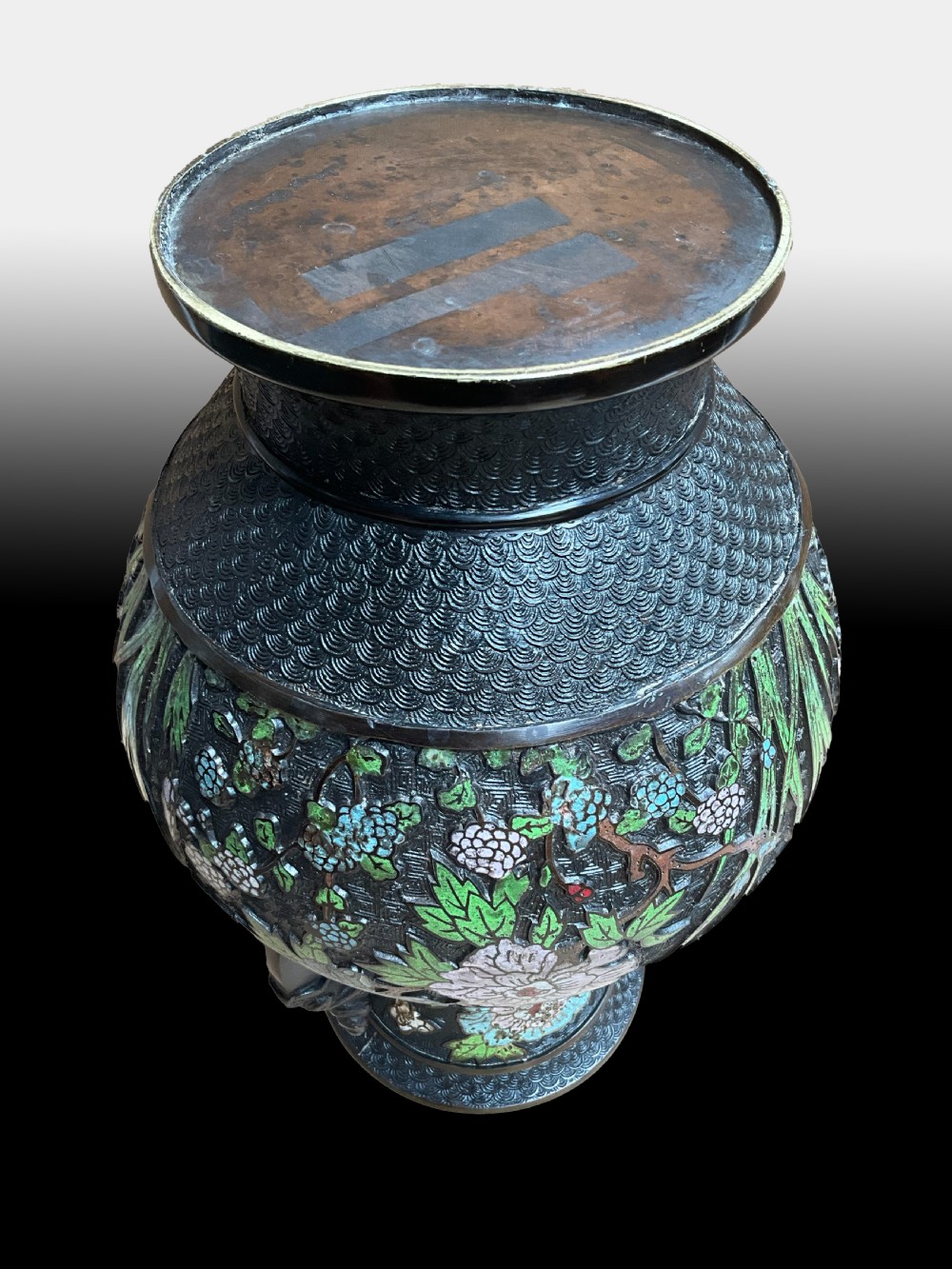 A late 19th-century Japanese bronze baluster vase featuring colourful enamel floral decorations and beast head loop handles. View II