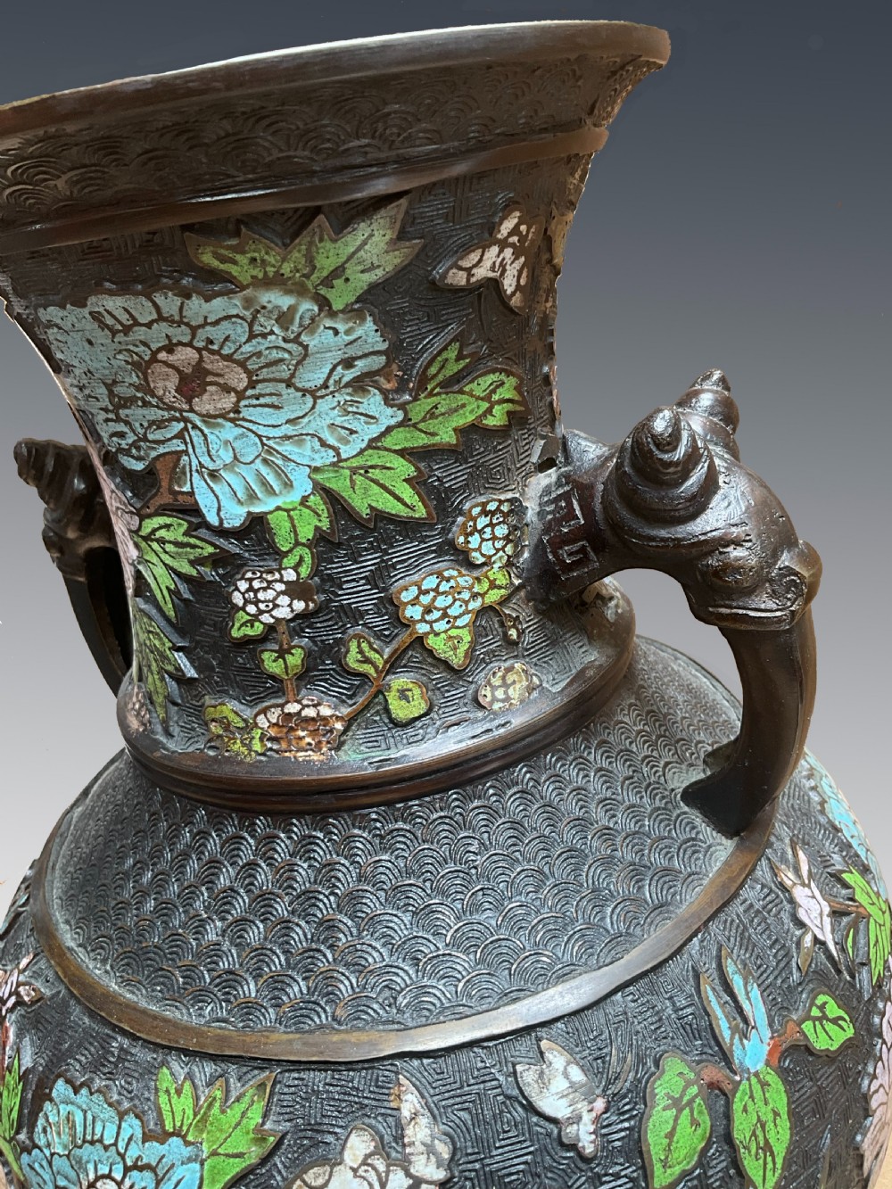 A late 19th-century Japanese bronze baluster vase featuring colourful enamel floral decorations and beast head loop handles. View III
