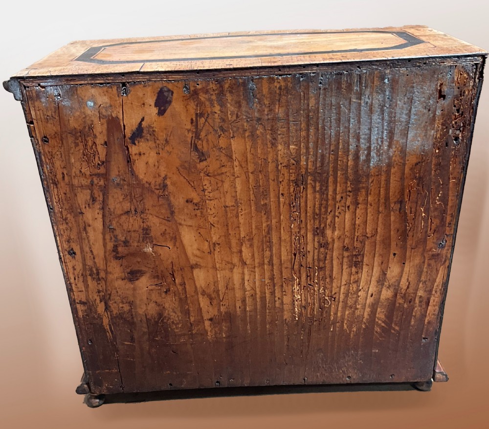 An early 19th century inlaid walnut serpentine fronted miniature chest of drawers View III